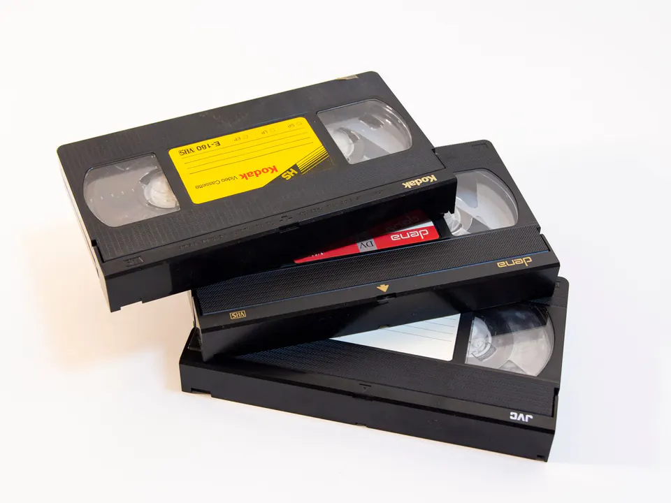 A stack of old VHS home video tapes ready to be transferred